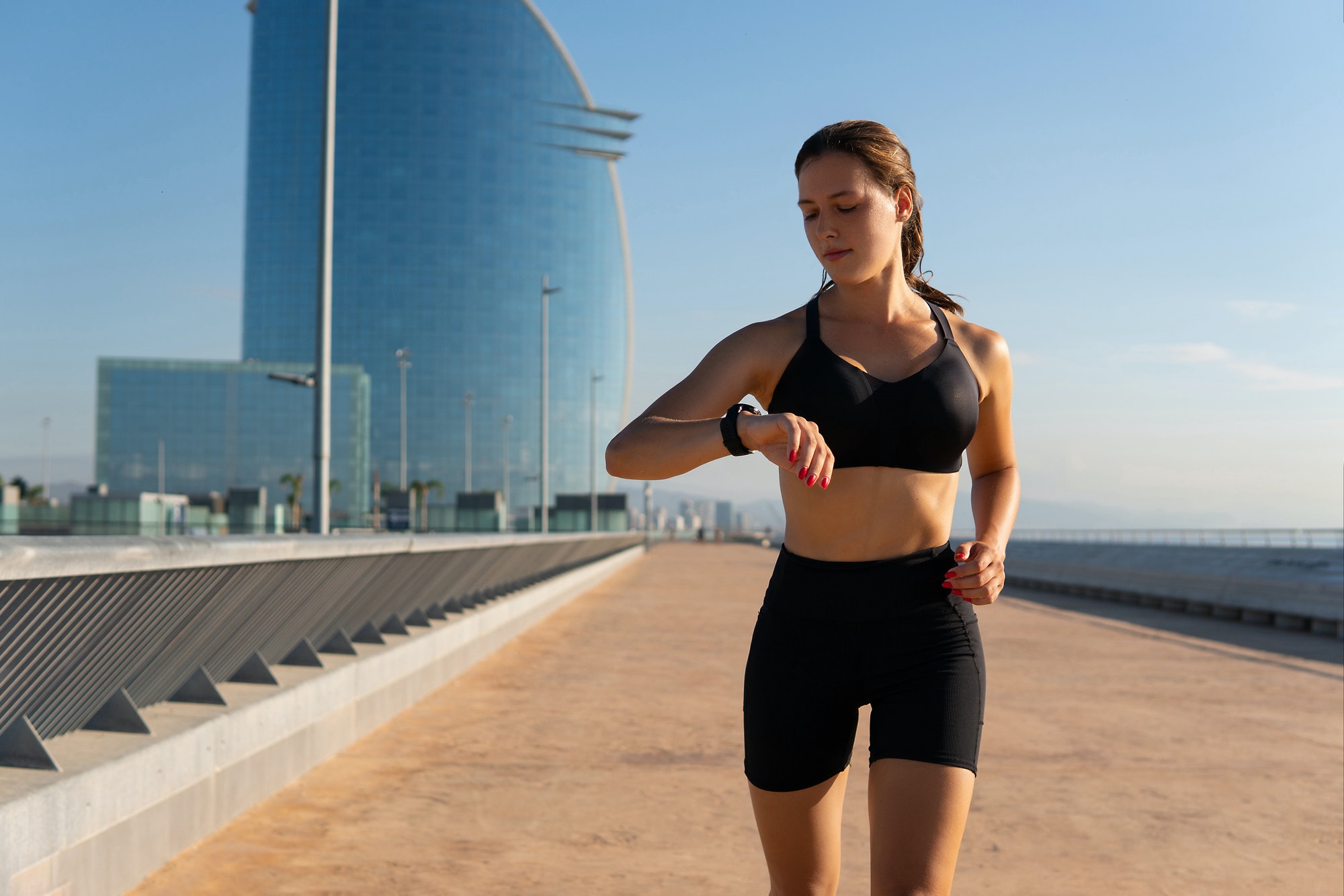 Female runner checking smart watch