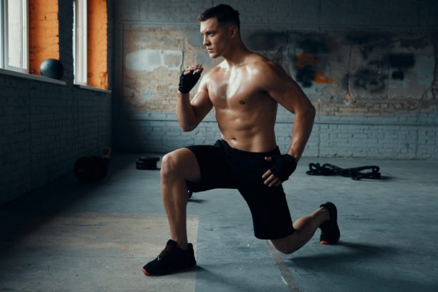 Full length of handsome young man warming up before training in gym