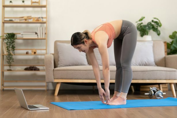 Young woman Exercising At Laptop Having Online Training At Home
